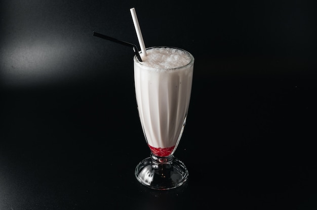 Closeup glass of milk shake isolated on black surface