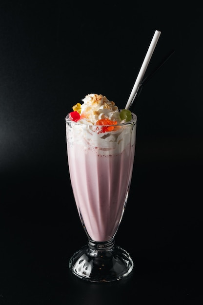 Closeup glass of milk shake isolated on black surface