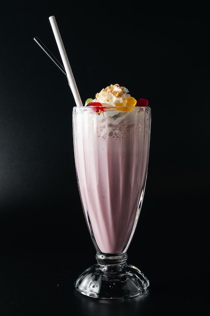 Closeup glass of milk shake isolated on black surface