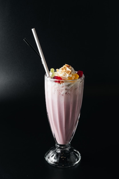 close up shot of strawberry milkshake with whipped cream In a