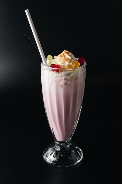 Closeup glass of milk shake isolated on black surface