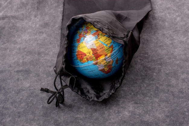 Closeup of a globe model in a black bag