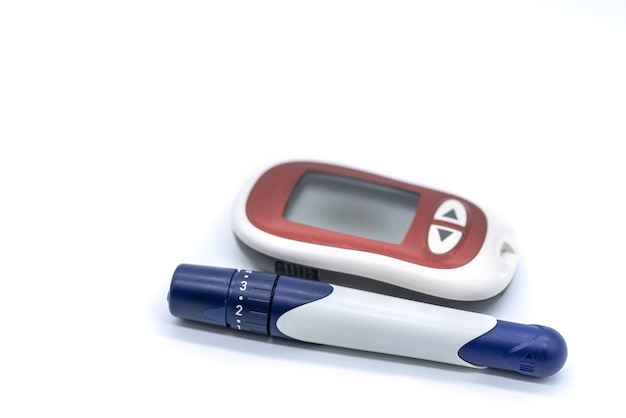 Photo closeup of glucose meter with lancet on white background use as medicine, diabetes, glycemia, health care and people concept.