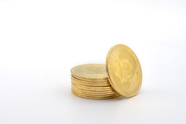 Closeup of gold bitcoin coins isolated on white background