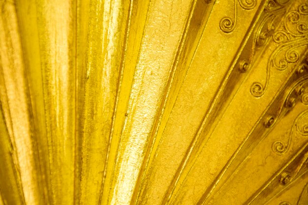 Closeup gold folding fan background