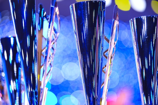 Photo closeup of golden trophies lined up at a dance event collection of trophies award cups close up