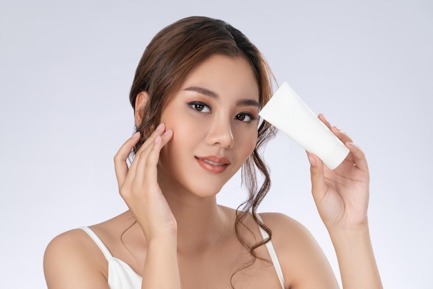 Closeup gorgeous girl with makeup holding mockup product for advertising