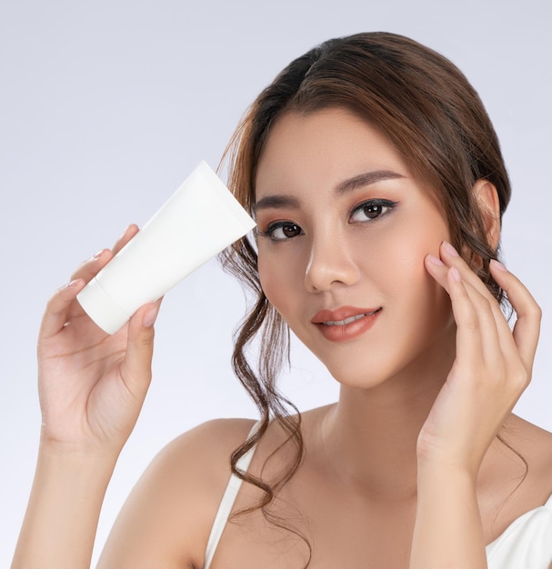 Closeup gorgeous girl with makeup holding mockup product for advertising