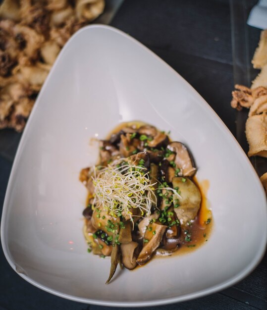 Closeup of a gourmet serving of a mushroom scramble in a fancy restaurant