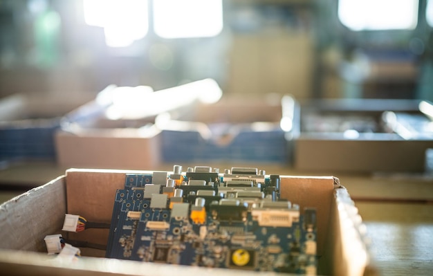 Closeup green embedded microcircuits are stacked in box to prepare for the further in factory for production of equipment