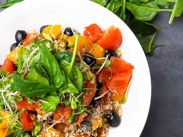 Closeup of green salad with spinach and vegetables seeds