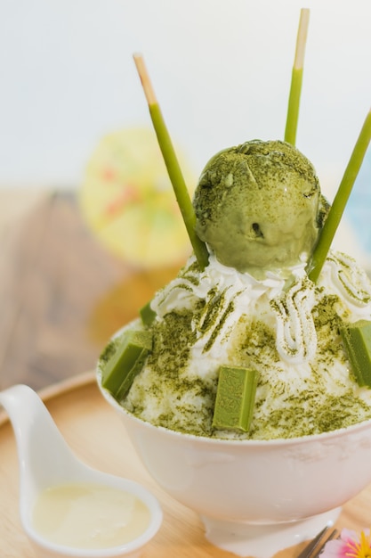 Closeup green tea Bingsu on tray, Bingsu or Bingsoo, Korean shaved ice dessert with sweet toppings a