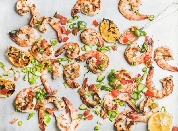 Closeup of grilled tiger prawns over white background top view