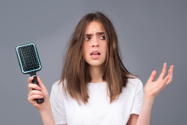 Closeup hair loss hair fall in hairbrush stress problem of\
woman with a comb