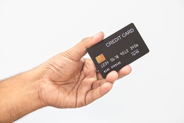 Closeup hand of Asian man holding black credit card in his hand isolated on white background Concept of finance trading communication social technology business