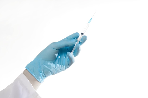 Closeup hand in blue glove holding transparent syringe without cap Isolated on white background