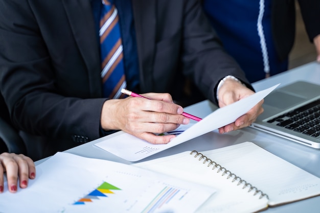 Closeup hand businessman writing on paper, Business team brainstorming researching and mar