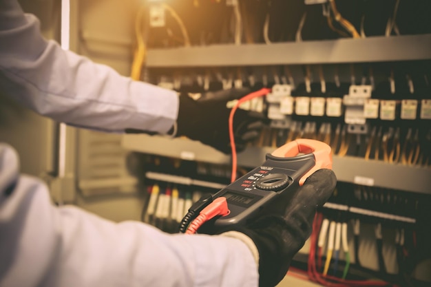 Closeup hand of electrical engineering using measuring to checking electricity