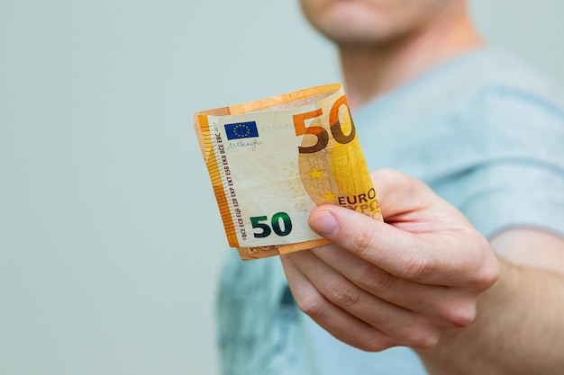 closeup of a hand holding 50 euro