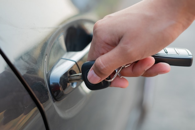 Closeup Hand holding car keys to unlock or lock.Woman with car key.