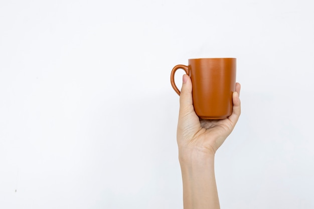 Closeup hand holding cup of coffee in white background