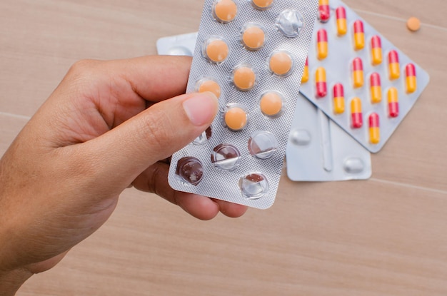 Closeup of hand holding a variety of medicine in pills and tablets vitality and health Perfect for illustrating treatments medical care pharmacy and wellness