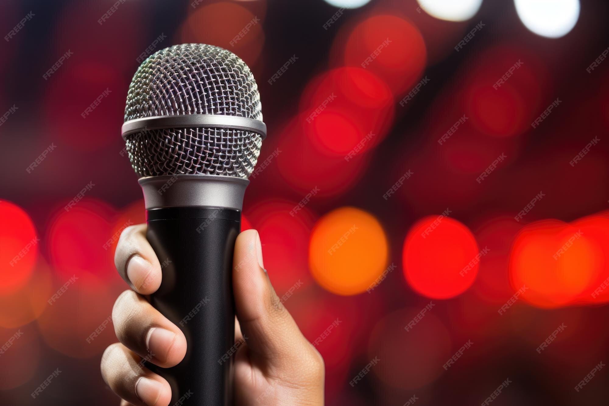 Premium AI Image Closeup Of A Hand Holding A Wireless Microphone With premium-ai-image-closeup-of-a-hand-holding-a-wireless-microphone-with