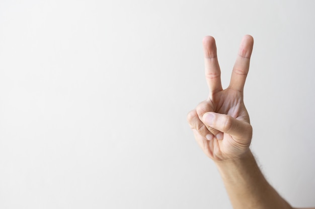 Closeup of hand indicating victory sign