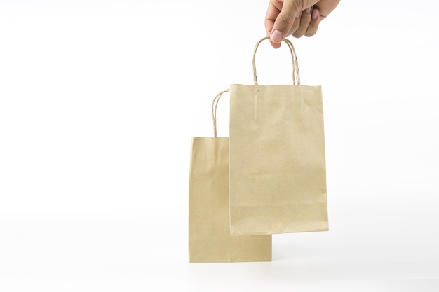 Closeup hand is holding a paper shopping bag