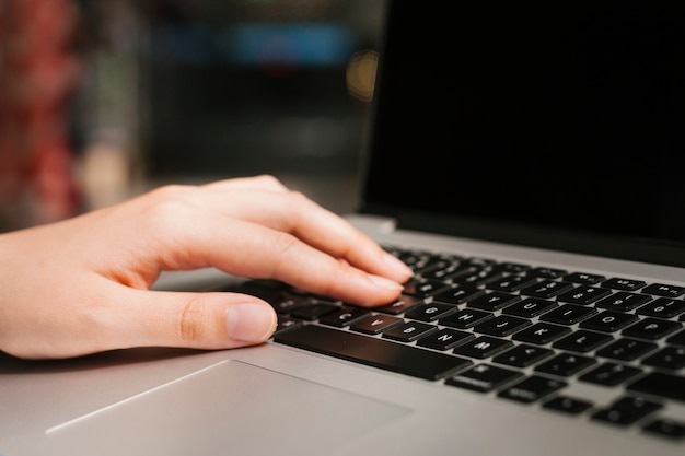 Closeup hand on laptop keyboard