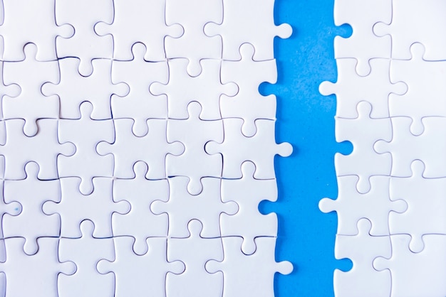 Closeup hand of man connecting jigsaw puzzle with sunlight effect