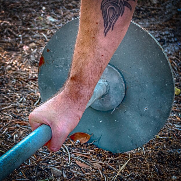 Closeup of hand on old barbell