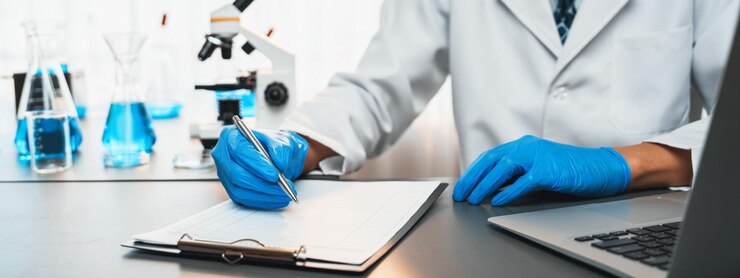 Photo closeup hand recording clinical data result after conducting chemical experiment in medical laboratory for vaccine drug or antibiotic scientific chemistry lab and medicine research concept neoteric