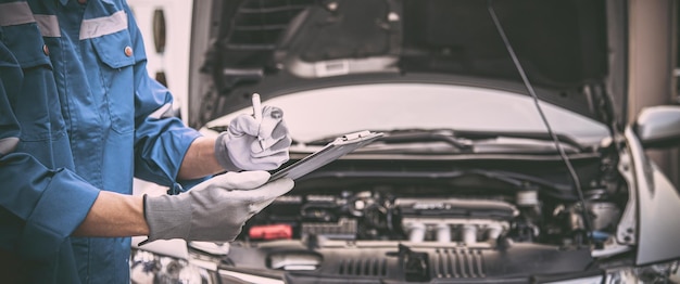 Closeup hand technician checking list after repairing