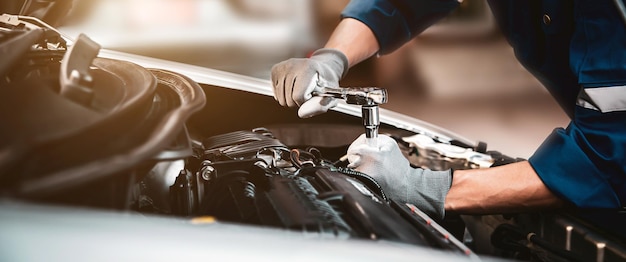 Closeup hand technician using the wrench to repairing car