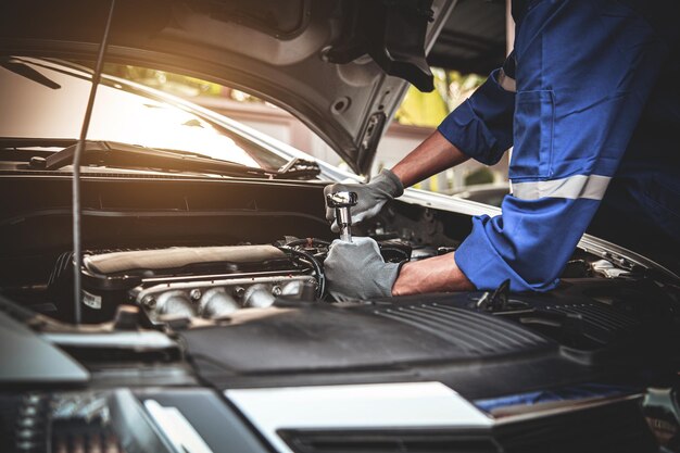 Closeup hand technician using the wrench to repairing car