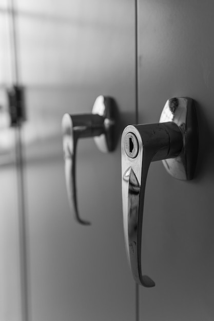 Photo closeup on the handle of the door filing cabinet in the office