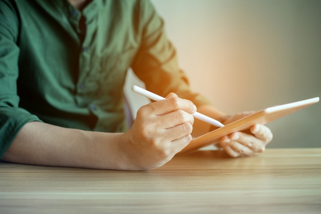 Photo closeup hands of businessman working with tablet at office