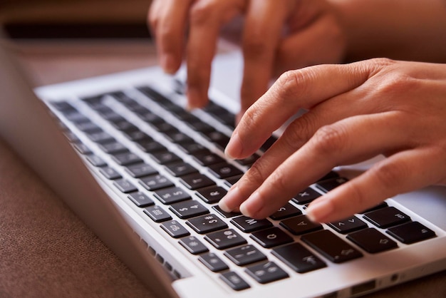 Closeup of the hands of businesswoman typing with a laptop