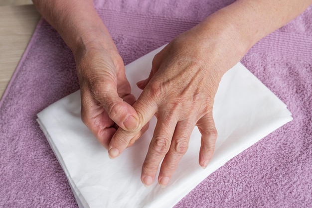 Closeup the hands of an elderly woman with wrinkles Self massage health care