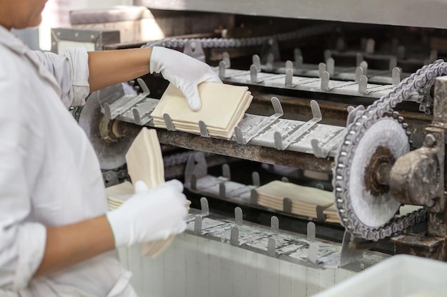 Closeup of the hands of an employee of a factory for the production of semifinished products