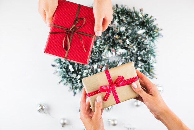 Closeup of hands giving gifts to each other