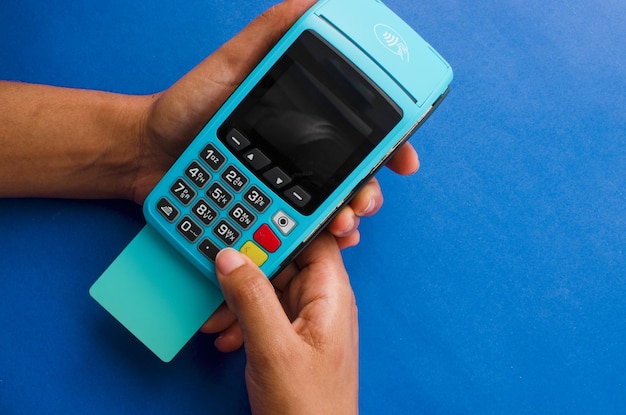 Closeup of hands holding a modern credit card payment device Contactless technology facilitating fast and secure transactions