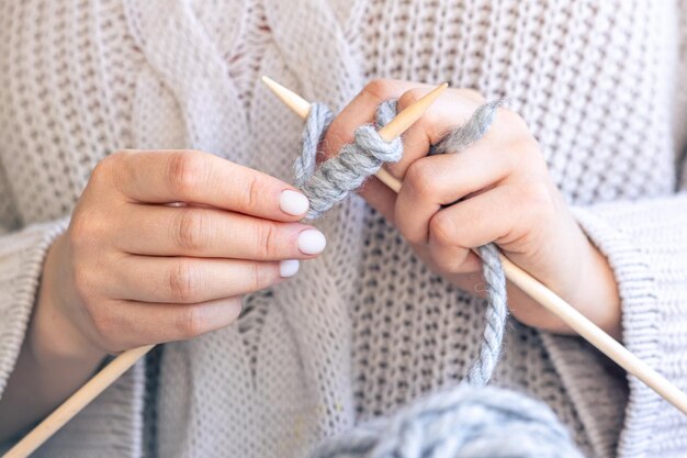 Photo closeup of hands knitting using circular needles