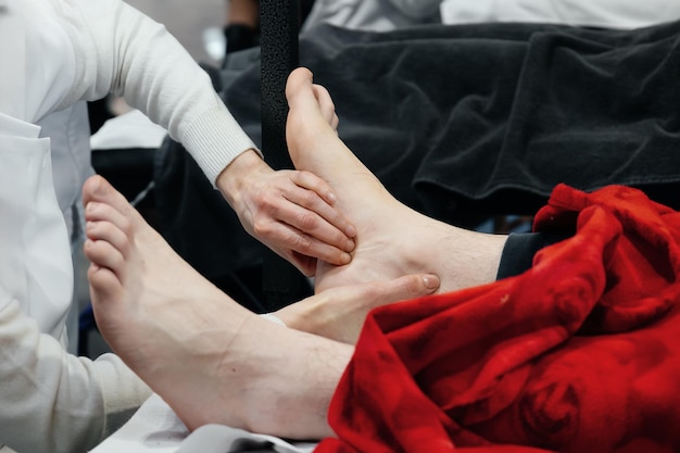 Photo closeup of hands mading massage foot