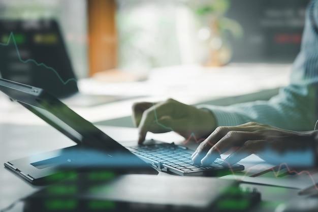 Closeup of hands resting on keyboard to view financial data business growth in the world of cryptocurrencies and the current global economy with war and volatility Finance and investment concepts