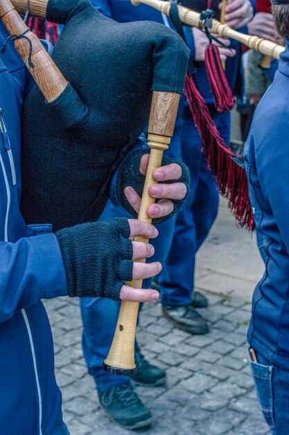 Closeup of the hands of a street musician playing the bagpipes