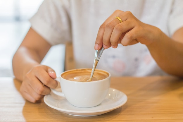 Closeup of hands with coffee cups in a cafe