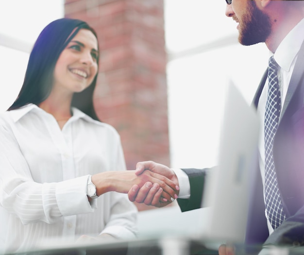 Closeup of handshake businessman and business woman business concept