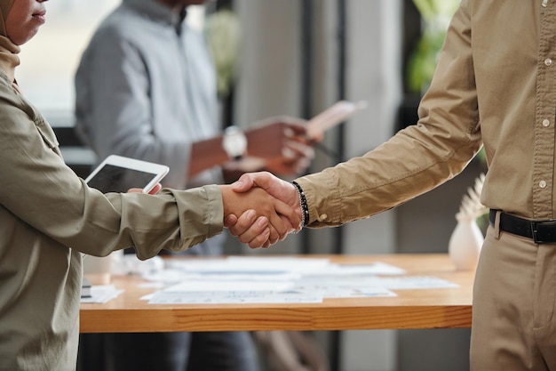 Closeup of handshake of two young intercultural business partners